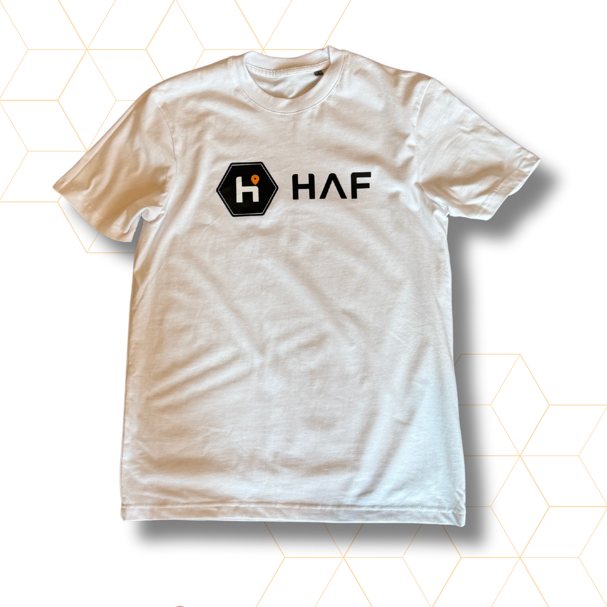 White t-shirt with a logo and text on a geometric patterned background